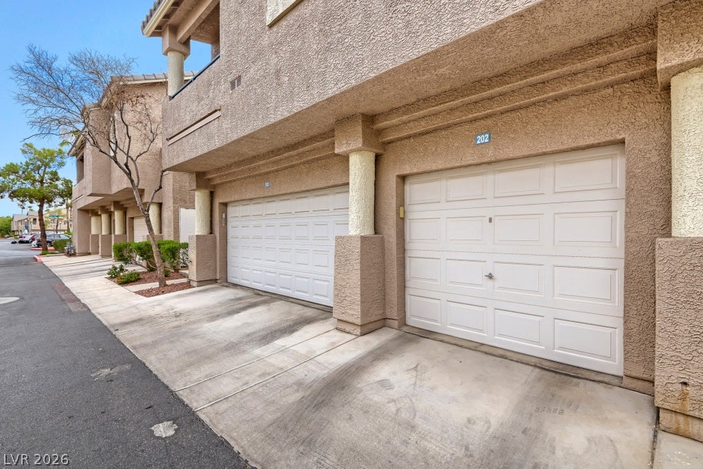 Stucco exteriors and concrete driveways lead to private ground-level garages.