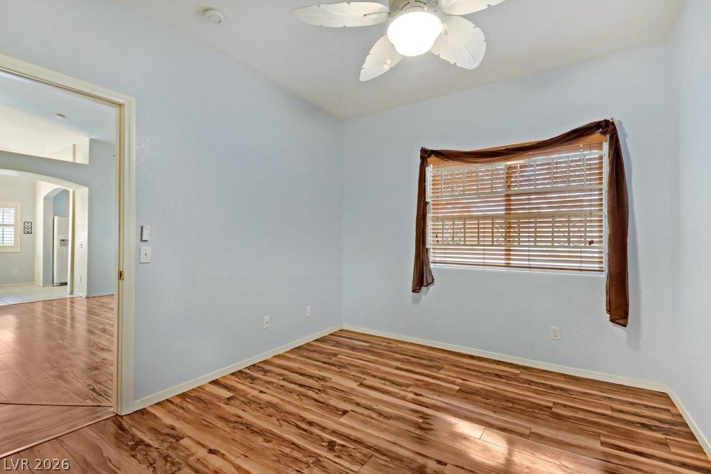 Rich wood flooring runs throughout this versatile secondary bedroom or home office space.
