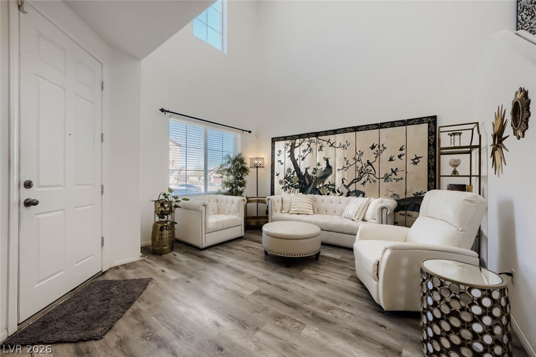 109 Spur Ranch Avenue, North Las Vegas, NV 89032 High ceilings and durable wood-look flooring define this welcoming main living area.
