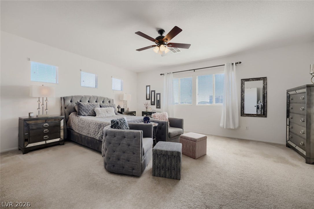 109 Spur Ranch Avenue, North Las Vegas, NV 89032 A spacious bedroom features neutral-toned carpet, numerous windows, and smooth drywall finishes.