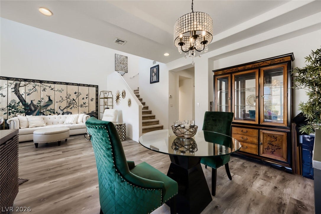 109 Spur Ranch Avenue, North Las Vegas, NV 89032 Smooth wood flooring and tiered ceilings define this open, airy dining space.