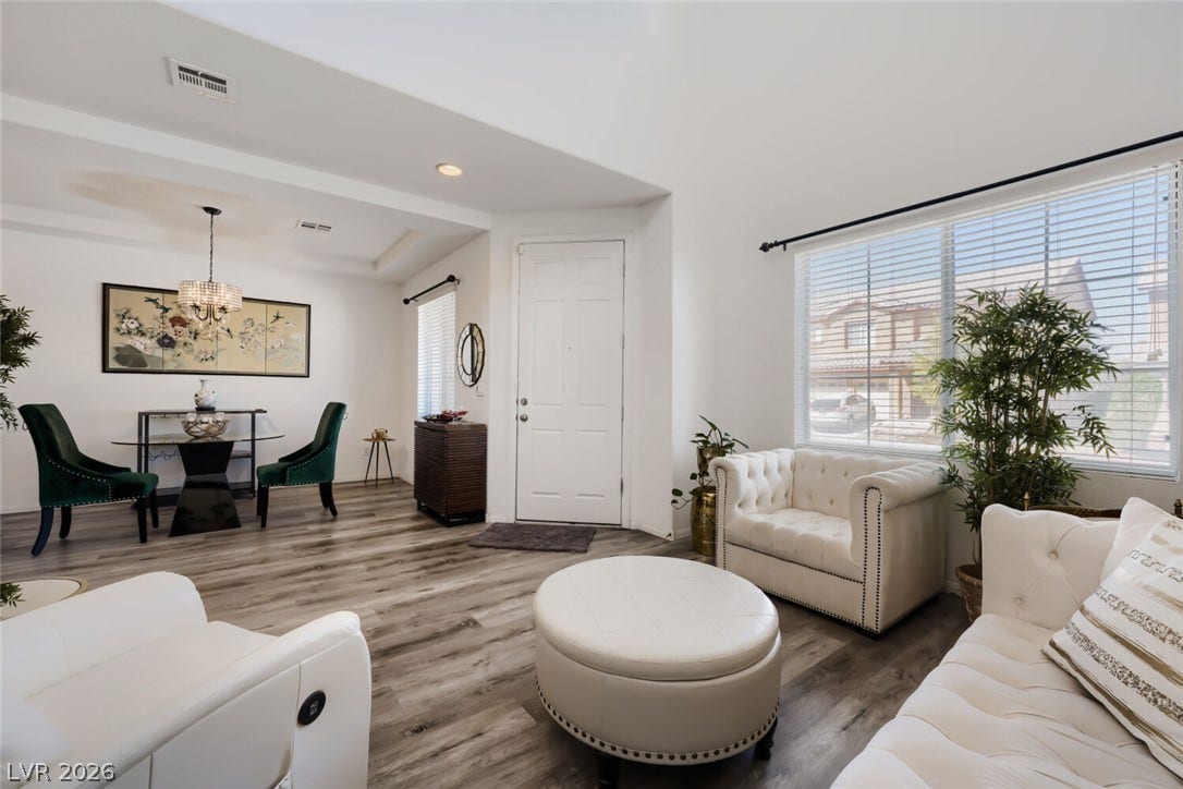 109 Spur Ranch Avenue, North Las Vegas, NV 89032 High ceilings and durable wood-look flooring define this welcoming open-concept entry and living area.
