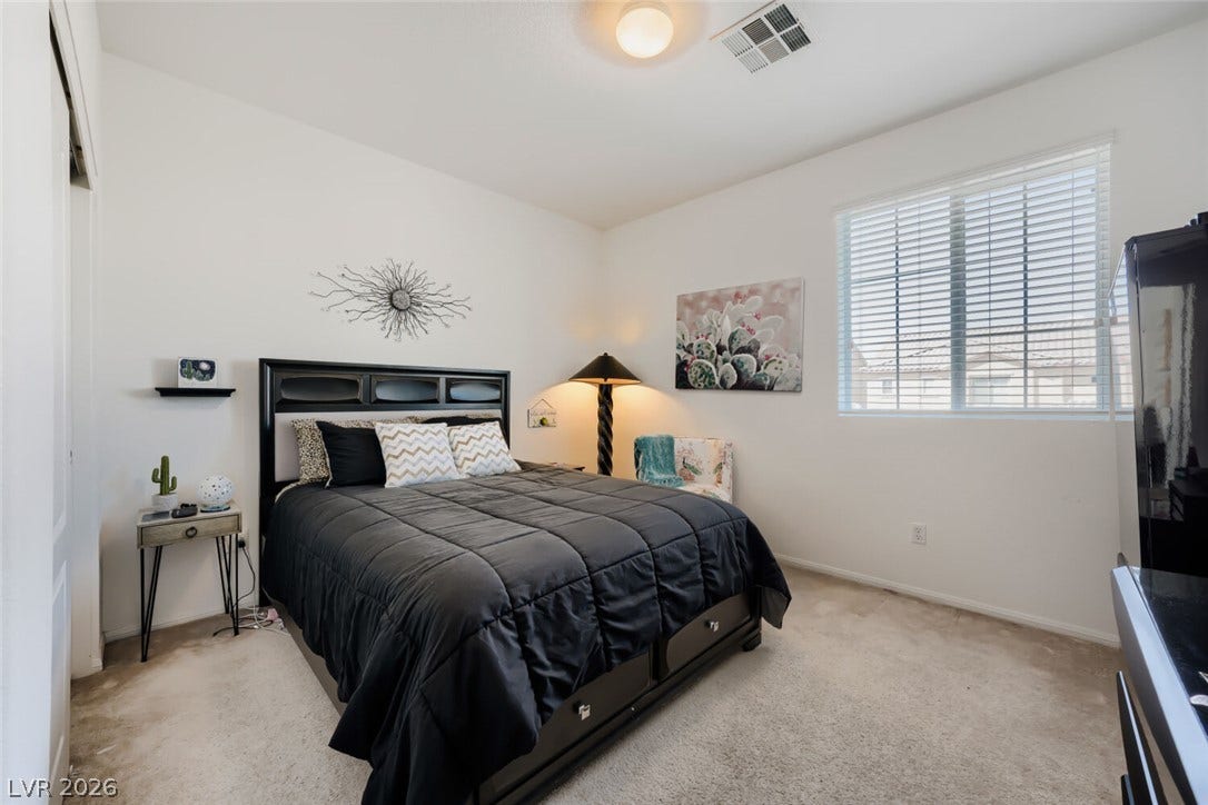 109 Spur Ranch Avenue, North Las Vegas, NV 89032 Plush carpeted flooring and a wide window create a comfortable, inviting atmosphere.