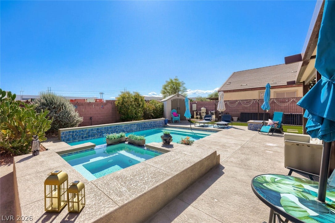 109 Spur Ranch Avenue, North Las Vegas, NV 89032 A sparkling in-ground pool and integrated spa define this concrete patio backyard oasis.