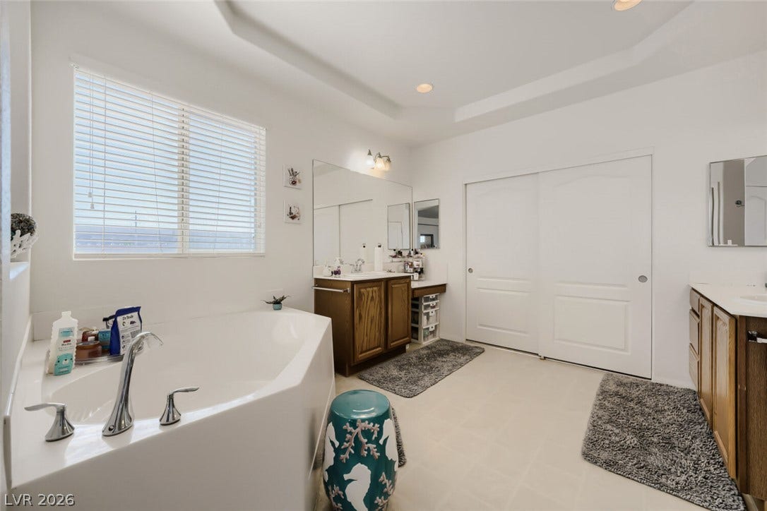 109 Spur Ranch Avenue, North Las Vegas, NV 89032 An alcove soaking tub and twin vanities anchor this spacious primary bath.