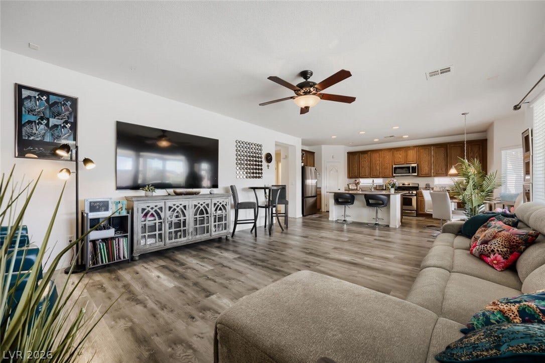 109 Spur Ranch Avenue, North Las Vegas, NV 89032 Smooth wood-look flooring connects this spacious living area directly to the kitchen.