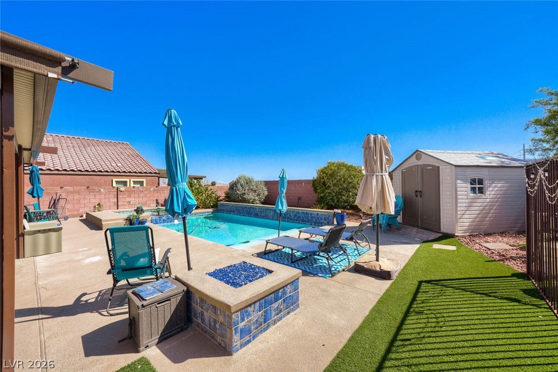 109 Spur Ranch Avenue, North Las Vegas, NV 89032 A sparkling swimming pool highlights this backyard oasis, complete with a built-in fire pit and patio.