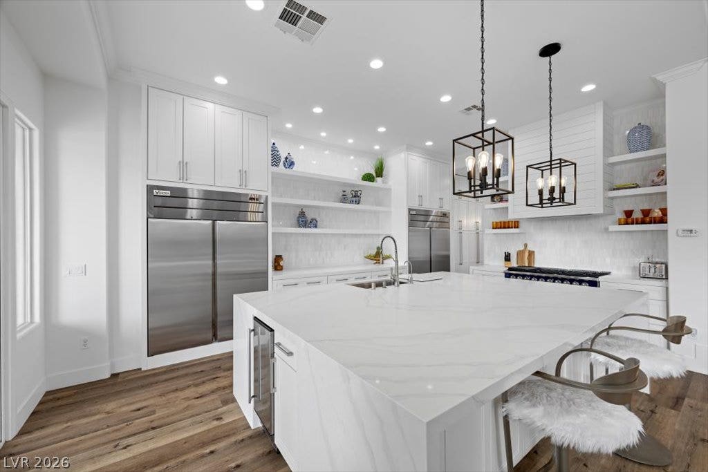 9521 Queen Charlotte Drive, Las Vegas, NV 89145 Gleaming stone countertops and premium appliances anchor this beautifully designed culinary space.