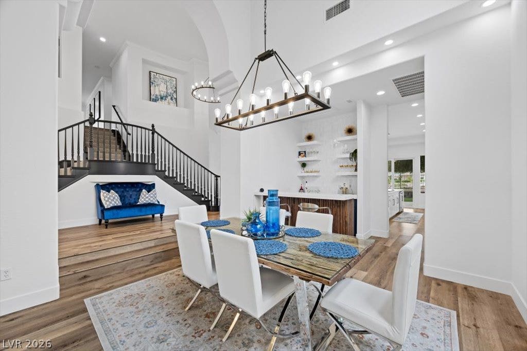 9521 Queen Charlotte Drive, Las Vegas, NV 89145 Gleaming hardwood floors and a striking staircase define this open dining area.