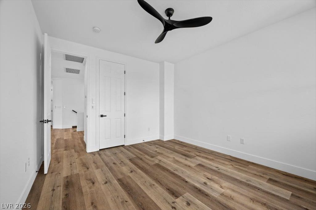9521 Queen Charlotte Drive, Las Vegas, NV 89145 Rich wood-toned flooring adds organic warmth to this minimalist modern bedroom.