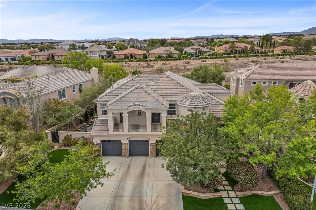 9521 Queen Charlotte Drive, Las Vegas, NV 89145 An elevated perspective showcases the multi-car garage, upper balcony, and tile roof design.