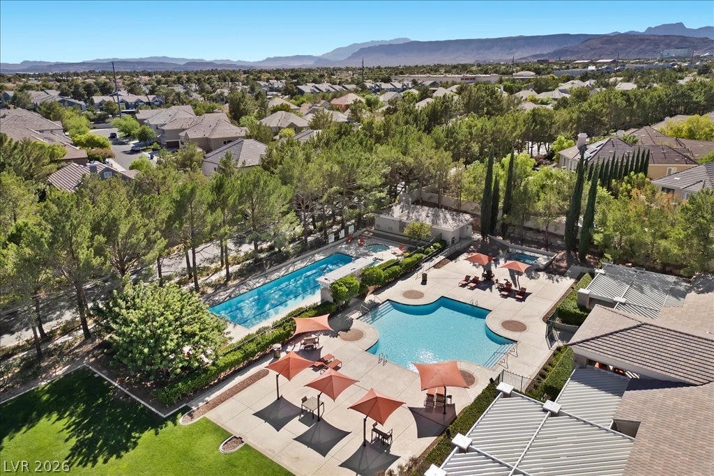 9521 Queen Charlotte Drive, Las Vegas, NV 89145 Lush mature landscaping surrounds the pristine community swimming pools with scenic mountain backdrops.