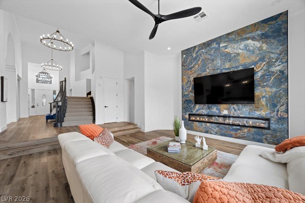 9521 Queen Charlotte Drive, Las Vegas, NV 89145 Gleaming wood floors and a contemporary fireplace wall define this split-level living area.