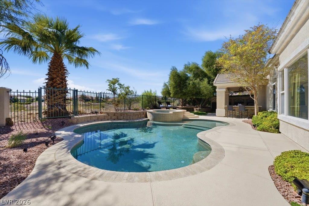 9521 Queen Charlotte Drive, Las Vegas, NV 89145 An inviting backyard oasis features a sparkling in-ground pool paired with a custom spa.