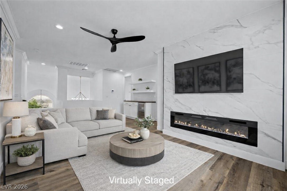 9521 Queen Charlotte Drive, Las Vegas, NV 89145 Elegant hardwood flooring anchors a contemporary living room with a sleek inset fireplace.