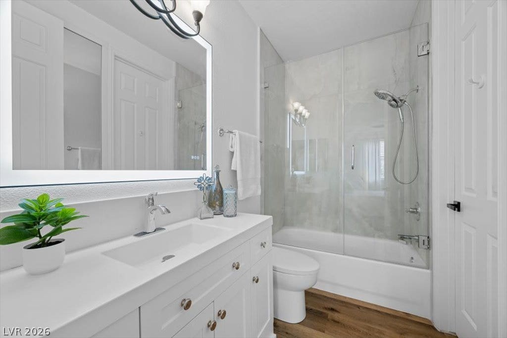 9521 Queen Charlotte Drive, Las Vegas, NV 89145 Clean lines and a modern vanity define this beautifully updated bath with rich wood floors.