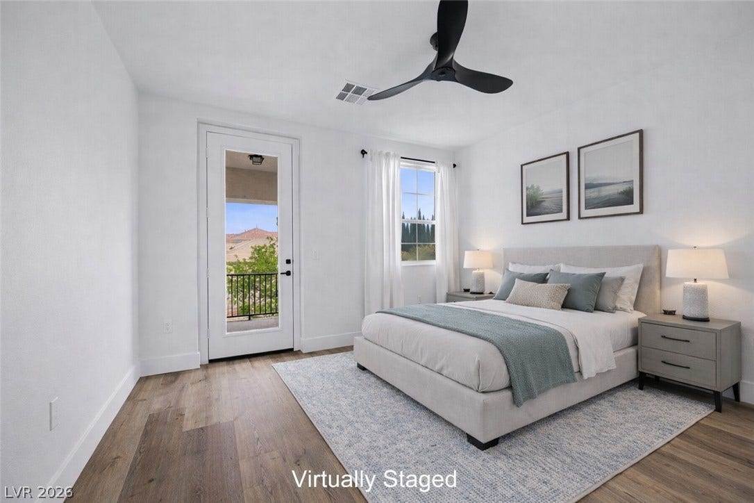 9521 Queen Charlotte Drive, Las Vegas, NV 89145 Warm wood flooring and direct outdoor access highlight this inviting bedroom retreat.
