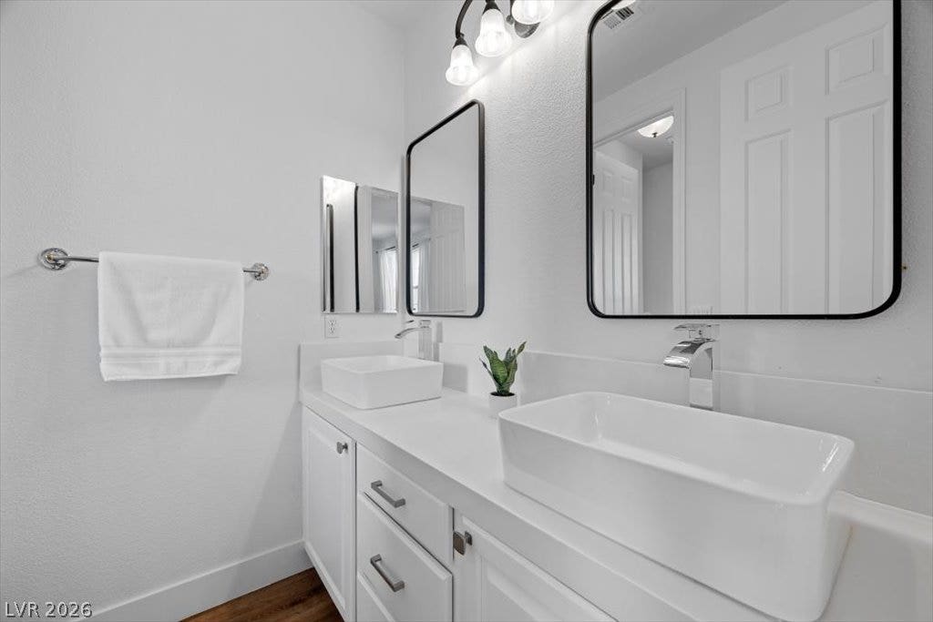 9521 Queen Charlotte Drive, Las Vegas, NV 89145 A contemporary vanity setup is highlighted by clean white surfaces and modern vessel sinks.