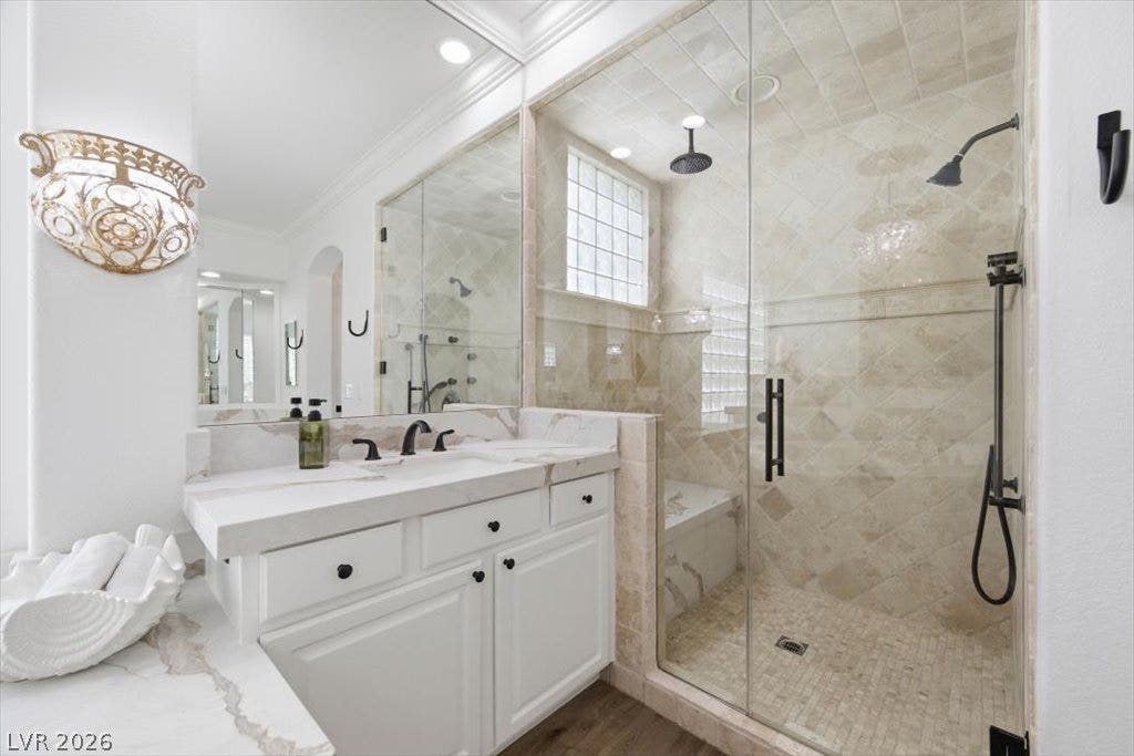 9521 Queen Charlotte Drive, Las Vegas, NV 89145 Premium stone tiling and sleek glass doors elevate this modern walk-in shower experience.