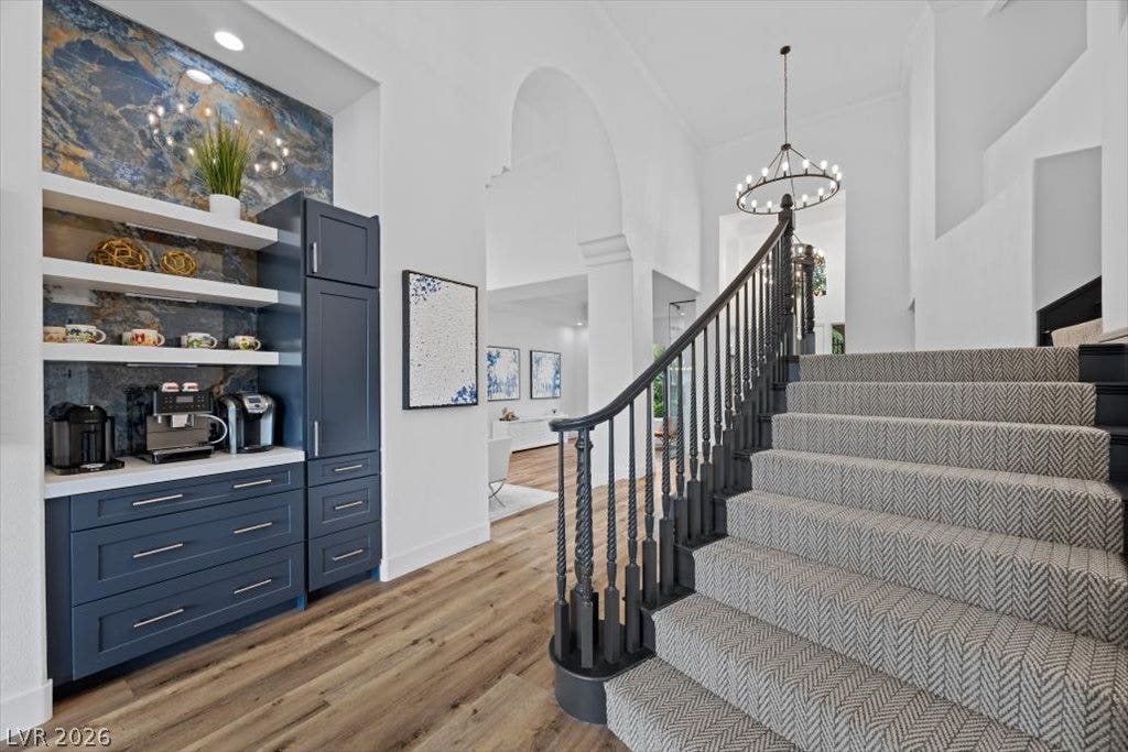 9521 Queen Charlotte Drive, Las Vegas, NV 89145 High ceilings and arched openings create a grand entry alongside custom built-in cabinetry.