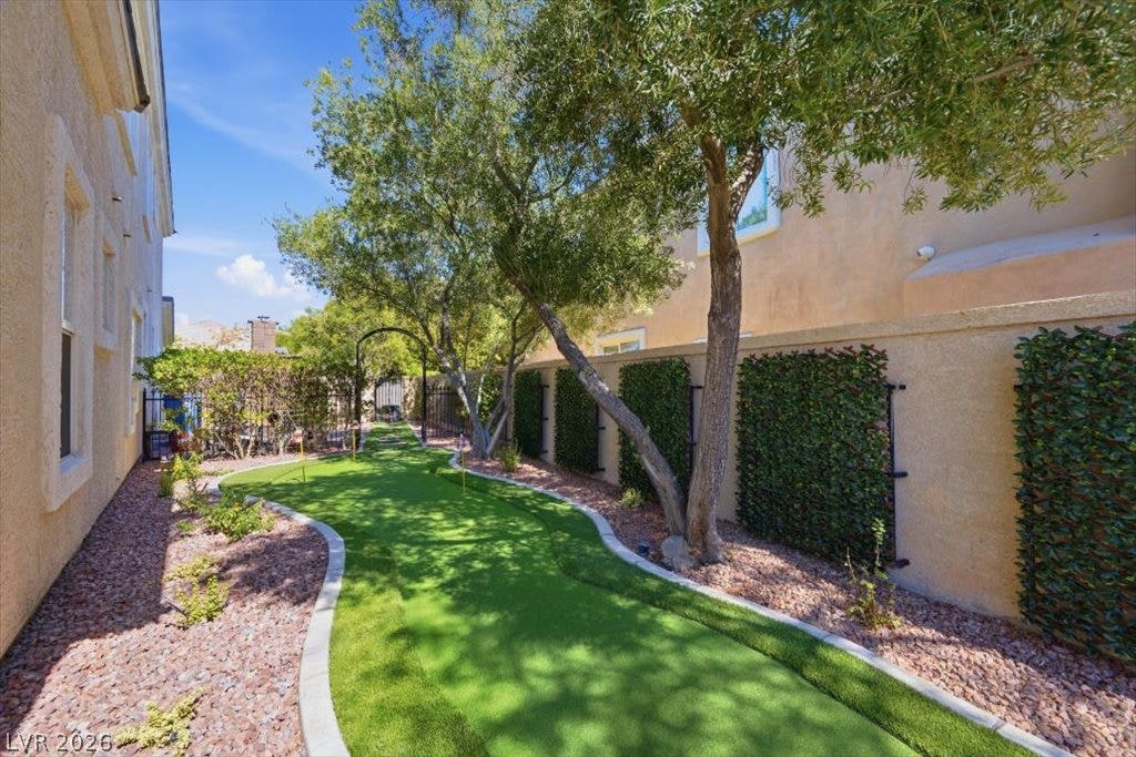 9521 Queen Charlotte Drive, Las Vegas, NV 89145 Mature trees shade a private putting green nestled alongside the home.