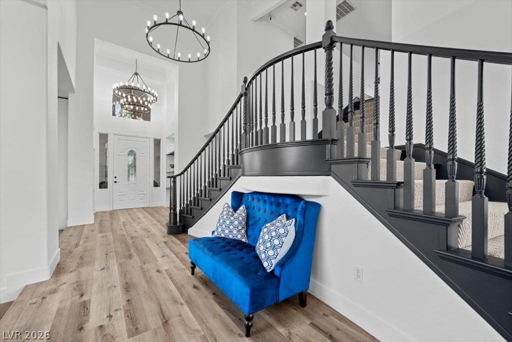 9521 Queen Charlotte Drive, Las Vegas, NV 89145 A sweeping staircase with dark railings makes a grand statement in this soaring entryway.
