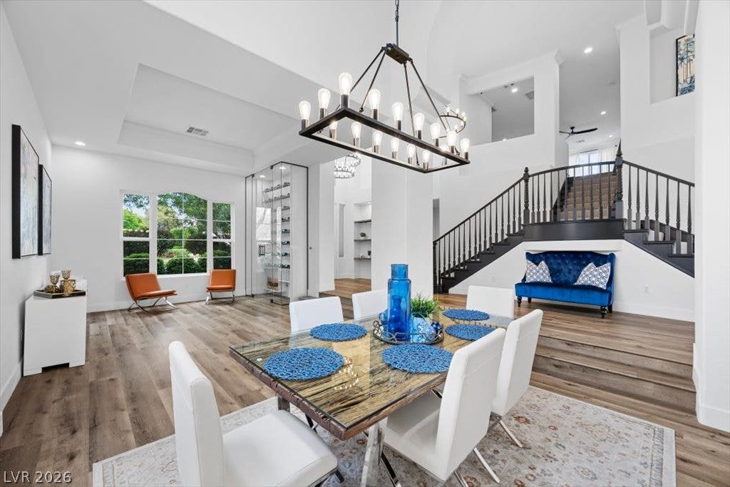 9521 Queen Charlotte Drive, Las Vegas, NV 89145 Soaring ceilings and rich wood floors frame this open, multi-level dining space.