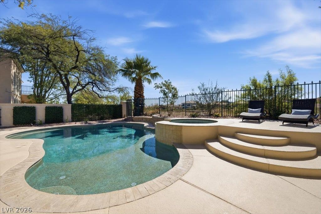 9521 Queen Charlotte Drive, Las Vegas, NV 89145 An inviting backyard oasis centers around a custom swimming pool and integrated elevated spa.