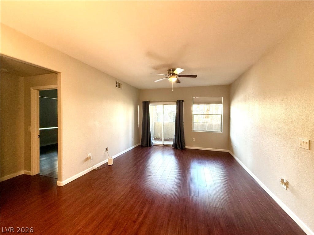 8777 W Maule Avenue, #1094, Las Vegas, NV 89148 Rich wood flooring runs throughout this spacious living area leading to sliding glass doors.