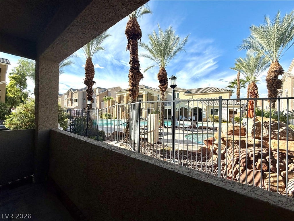 8777 W Maule Avenue, #1094, Las Vegas, NV 89148 Palm trees frame the view from this covered patio overlooking the community pool area.