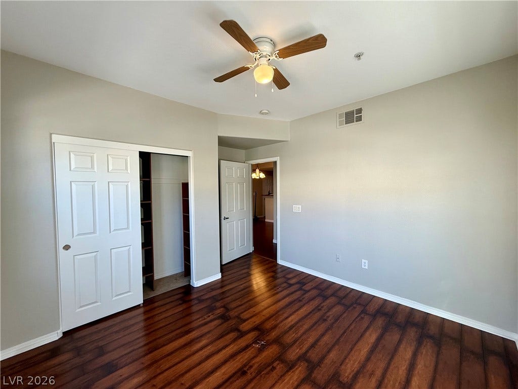8777 W Maule Avenue, #1094, Las Vegas, NV 89148 Rich hardwood flooring pairs beautifully with neutral walls in this versatile bedroom.