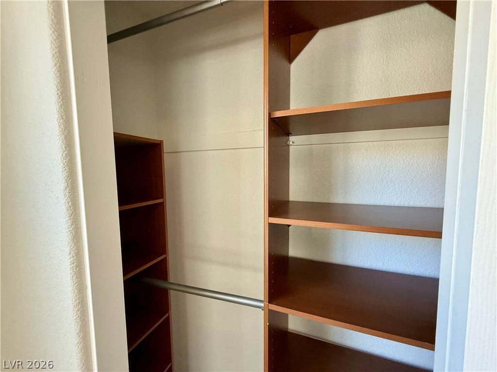 8777 W Maule Avenue, #1094, Las Vegas, NV 89148 Custom built-in shelving and hanging rods maximize storage efficiency within this walk-in closet.