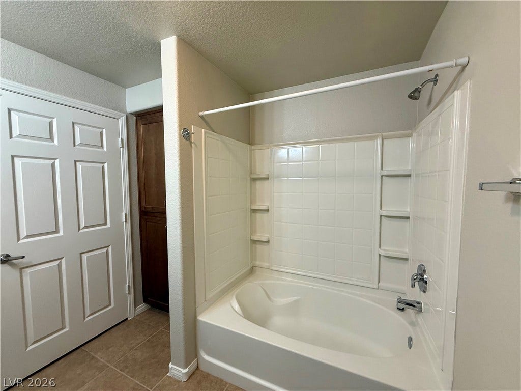 8777 W Maule Avenue, #1094, Las Vegas, NV 89148 A deep soaking tub highlighted by tiled surrounds sits adjacent to a private entry.