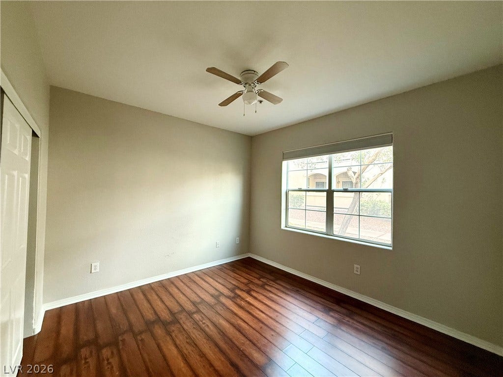 8777 W Maule Avenue, #1094, Las Vegas, NV 89148 Gleaming hardwood floors and a wide window create an inviting secondary bedroom retreat.