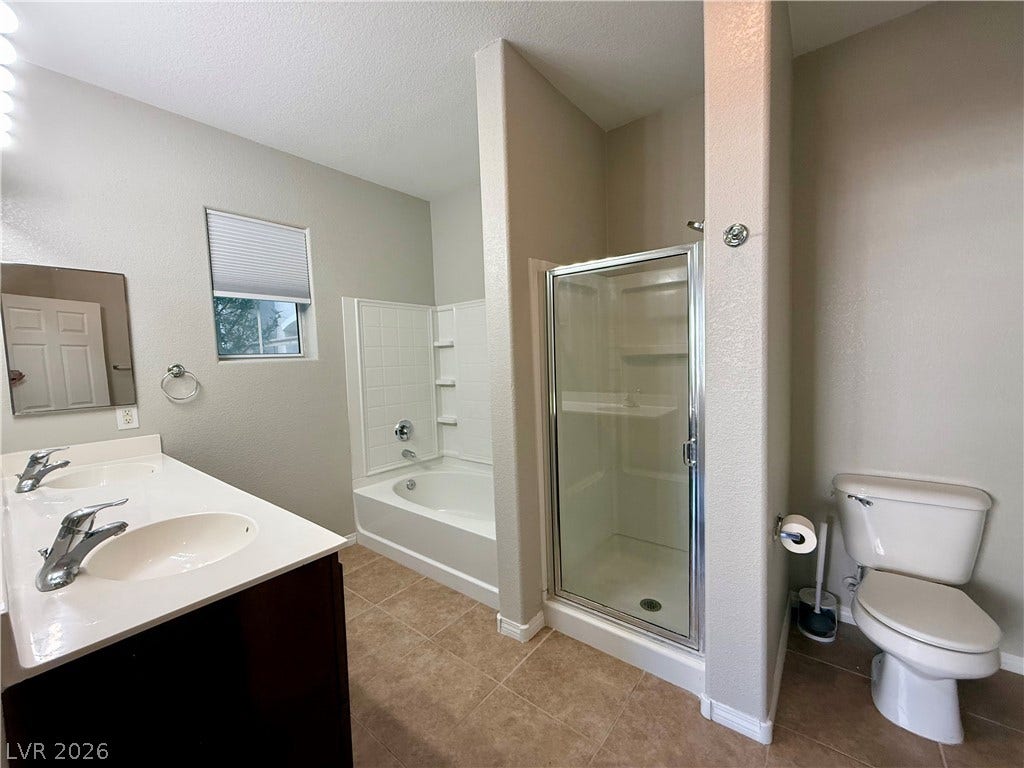 8777 W Maule Avenue, #1094, Las Vegas, NV 89148 A spacious layout highlights this bathroom with a dual sink vanity, tub, and separate shower.