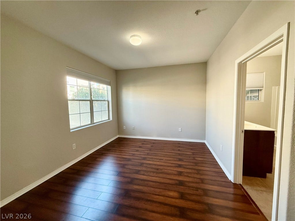8777 W Maule Avenue, #1094, Las Vegas, NV 89148 Rich wood flooring grounds this versatile room with seamless access to an adjoining bathroom.