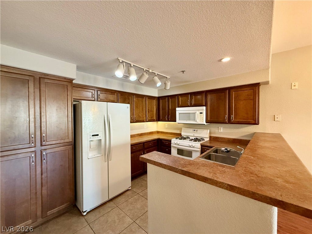 8777 W Maule Avenue, #1094, Las Vegas, NV 89148 Rich wood cabinetry contrasts beautifully with durable tile flooring and warm countertops.