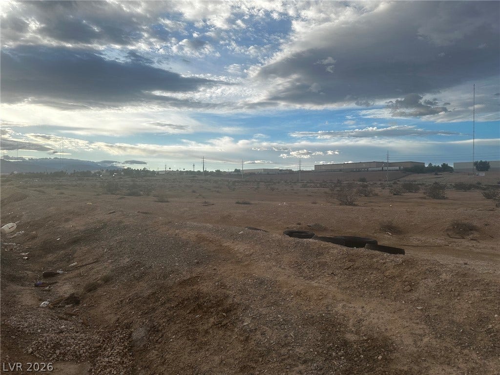 0 Reverend Wilson Ave, North Las Vegas, NV 89030 A vast desert landscape stretches out under a sweeping sky filled with dramatic clouds.