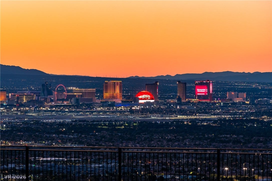 7 Sunset Strip, Henderson, NV 89012 Gaze across the sparkling city skyline framed by majestic mountain silhouettes at twilight.