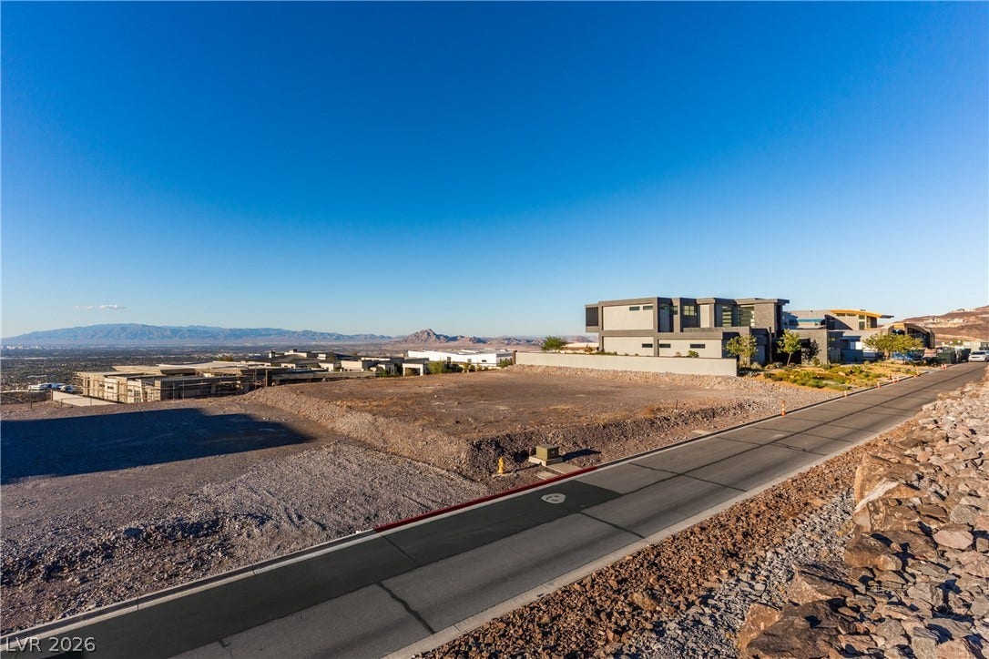 7 Sunset Strip, Henderson, NV 89012 A cleared building site overlooks a wide desert valley under vast blue skies.