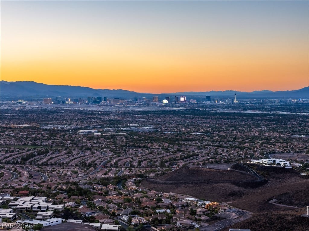 7 Sunset Strip, Henderson, NV 89012 Panoramic mountain and city skyline views unfold under a dramatic twilight sky.