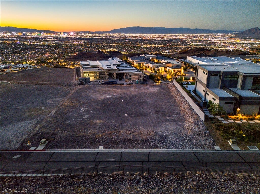7 Sunset Strip, Henderson, NV 89012 Elevated hillside lot overlooking a panoramic city skyline at twilight.