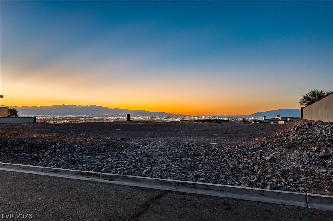 7 Sunset Strip, Henderson, NV 89012 Distant city lights and mountain ridges frame this expansive building lot at sunset.