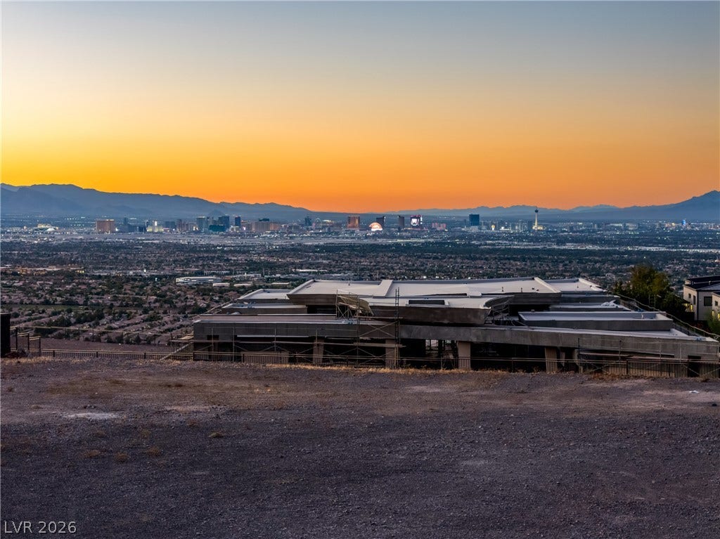 7 Sunset Strip, Henderson, NV 89012 Dramatic sunset skies frame a panoramic overlook of the distant city lights and mountain ranges.