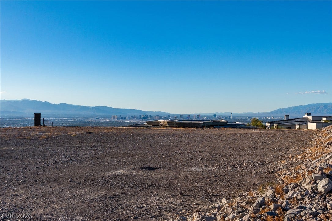7 Sunset Strip, Henderson, NV 89012 An elevated building site overlooks far-reaching city skyline and mountain views under blue skies.