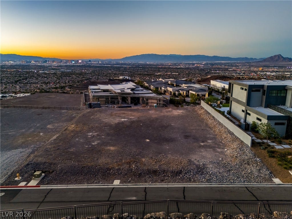 7 Sunset Strip, Henderson, NV 89012 An elevated perspective showcases a prime building lot overlooking distant mountains and twinkling city lights.