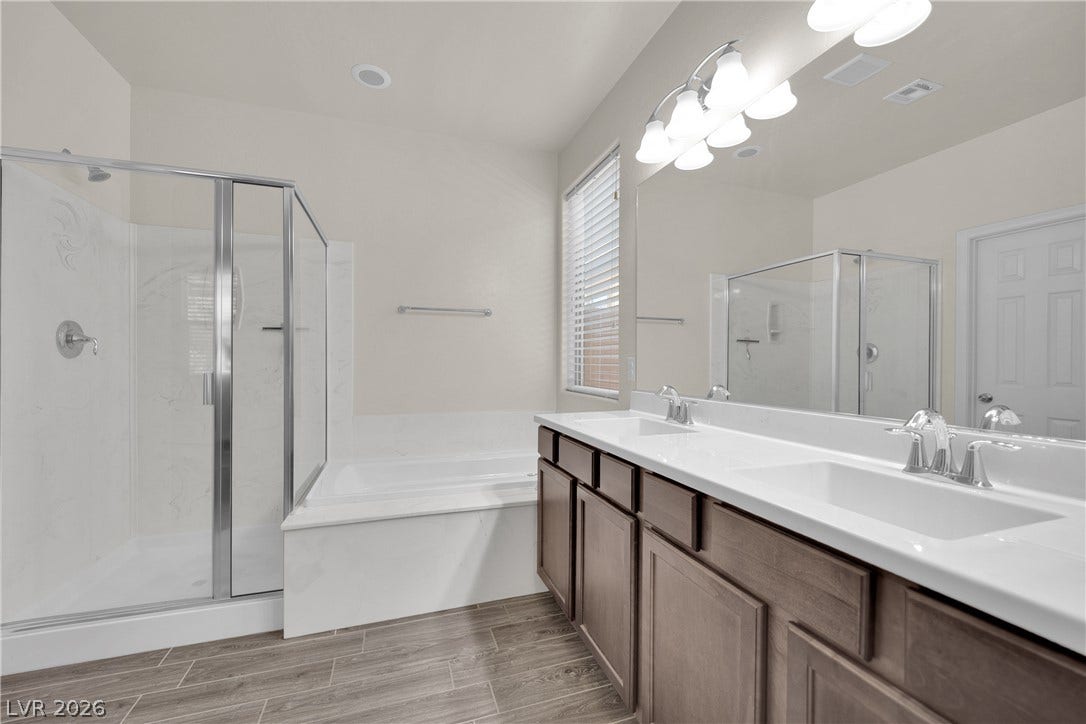 Primary bathroom with dual vanity, separate tub and shower