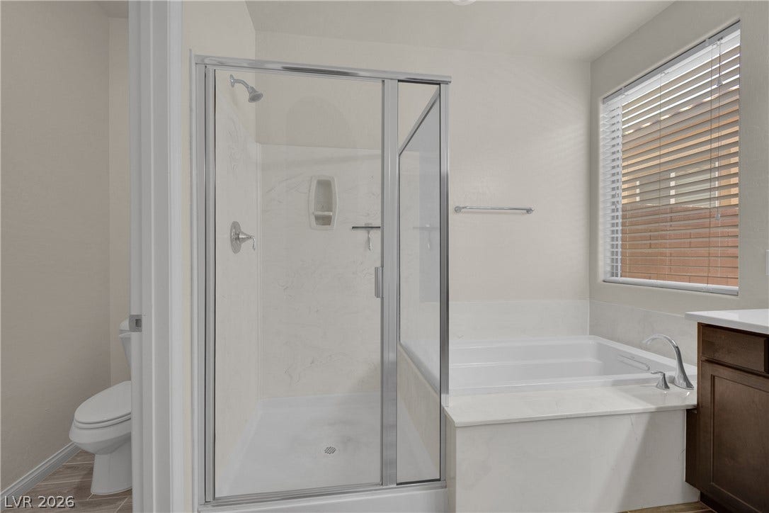 Primary bathroom with dual vanity, separate tub and shower