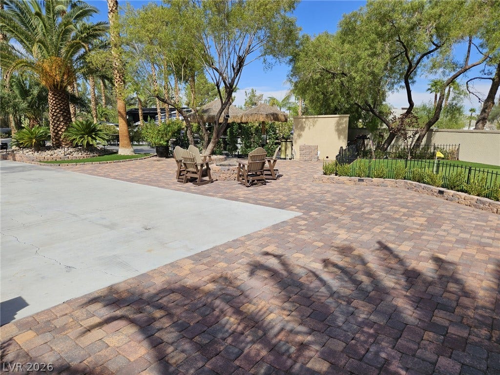 8175 Arville Street, #33, Las Vegas, NV 89139 Lush palm trees and neat paver stonework define this inviting outdoor courtyard retreat.