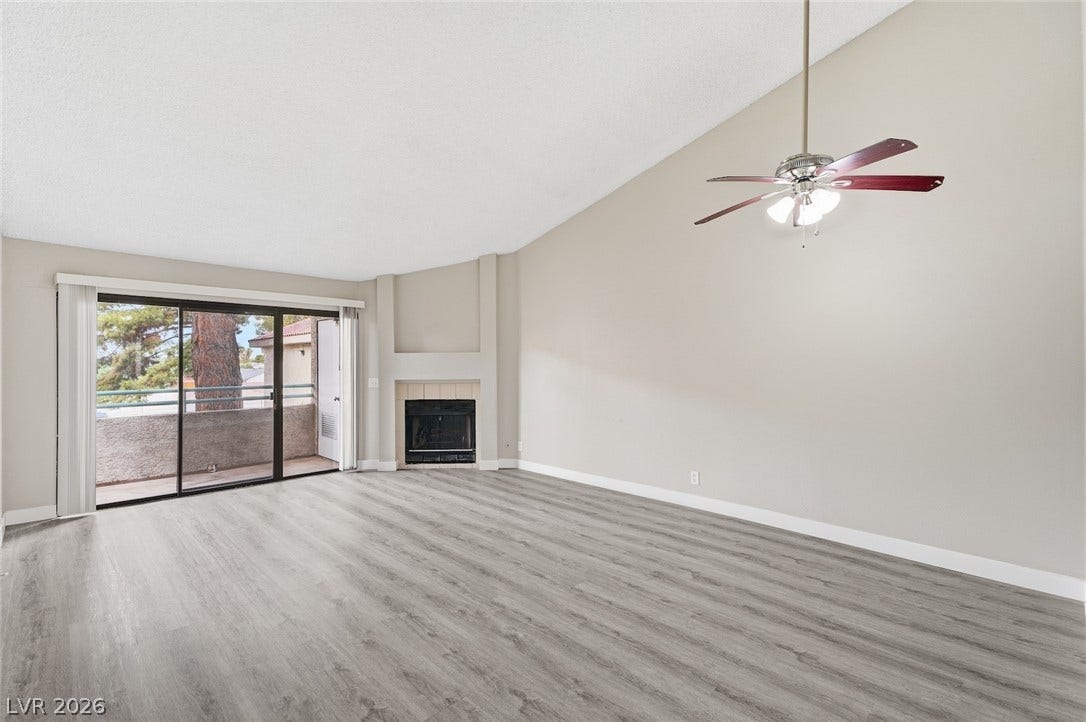 830 N Sloan Lane, #202, Las Vegas, NV 89110 A vaulted ceiling and wood-look flooring enhance this inviting space featuring a corner fireplace.